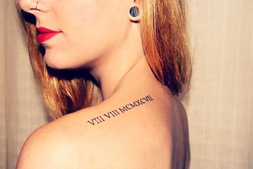Red girl’s lips and shoulder Roman numeral tattoo