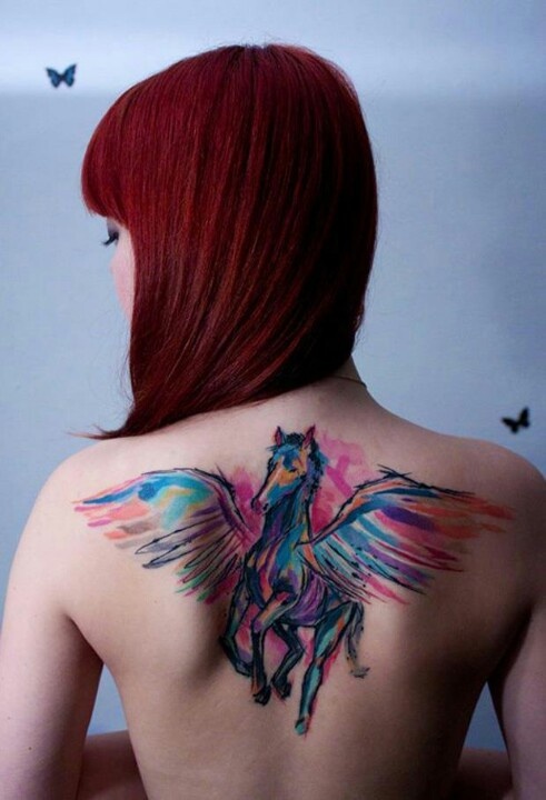 Red hair girl’s unicorn tattoo