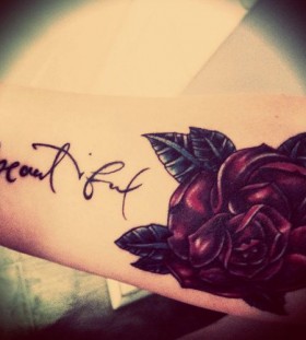 Red rose arm tattoo