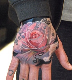 Rose hand tattoo by Phil Garcia