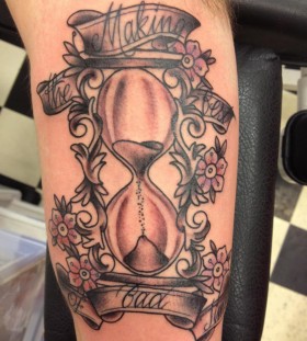 Sand clock and flowers tattoo