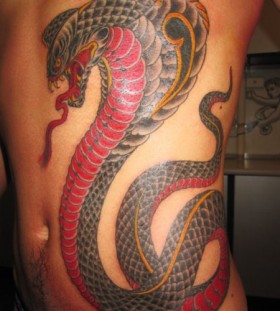 Scary cobra side tattoo