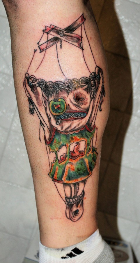 Scary puppet leg tattoo
