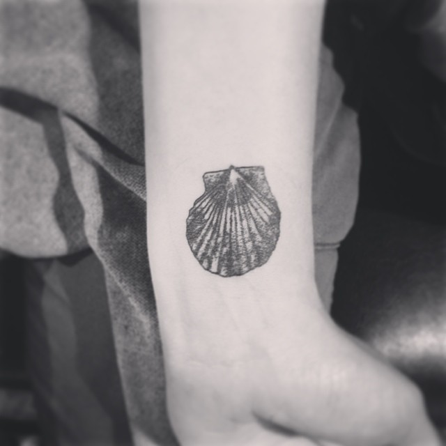 Sea shell arm tattoo