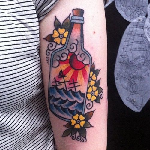 Sea, sun and crosses bottle tattoo