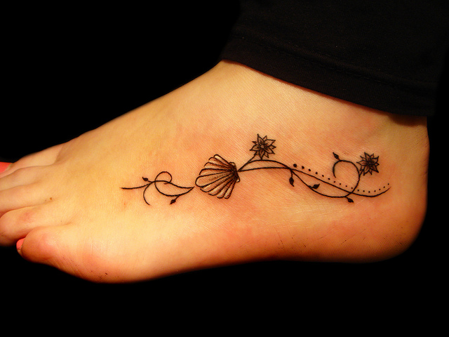 Shell and flower foot tattoo