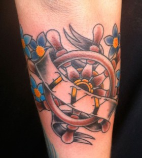 Ship's wheel arm tattoo