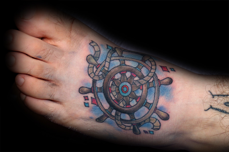 Ship’s wheel foot tattoo