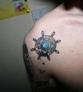 Ship's wheel shoulder tattoo