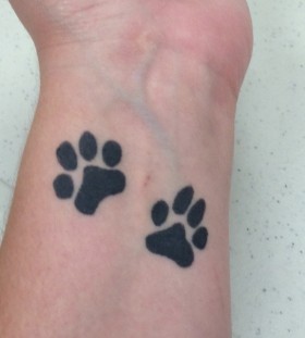 Simple paw arm tattoo