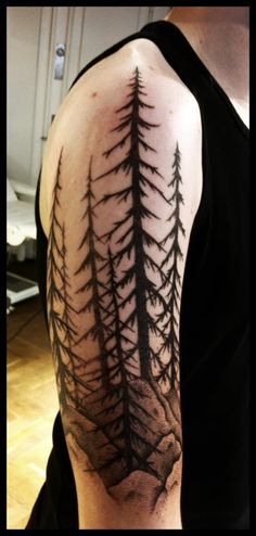 Simple pine trees arm tattoo