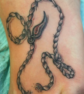 Simple rope foot tattoo
