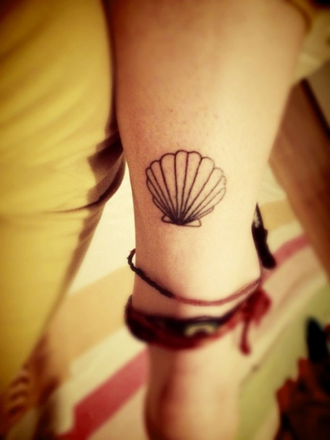 Simple shell arm tattoo