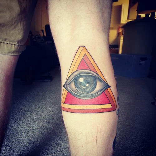 Simple triangle eye arm tattoo