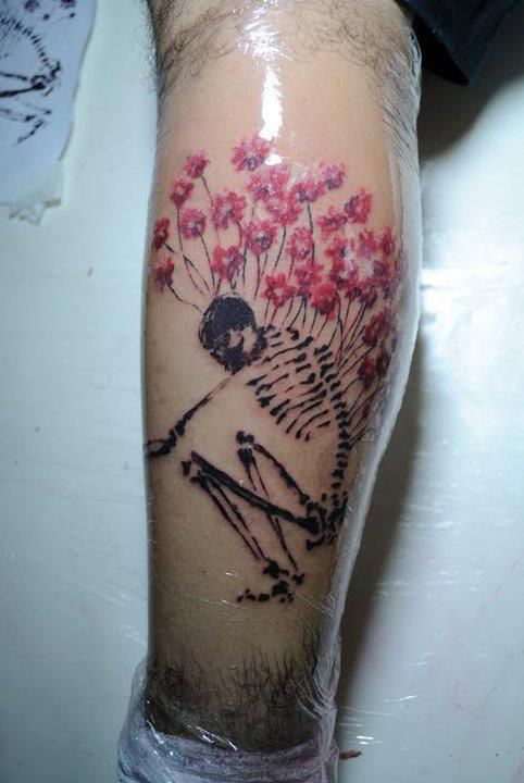 Skeleton and flowers tattoo by Tyago Compiani