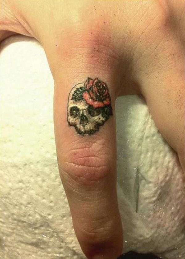 Skull and red rose tiny tattoo