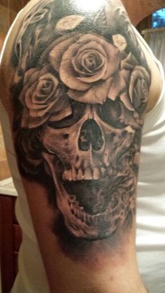 Skull and roses arm tattoo by Razvan Popescu
