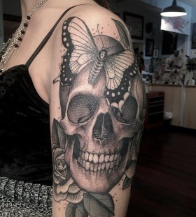 Skull rose and moth tattoo