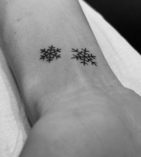 Small black snowflake christmas tattoo