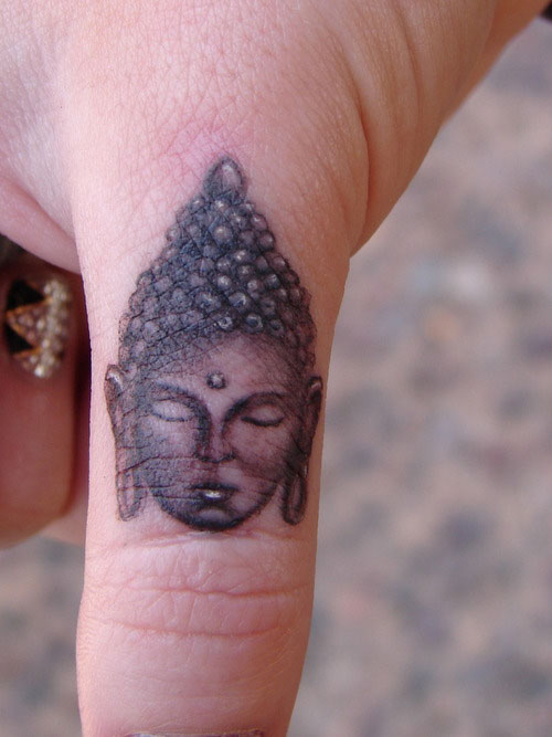 Small buddha finger tattoo