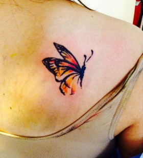 Small red watercolor butterfly tattoo