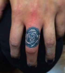 Small rose finger tattoo by Jon Mesa