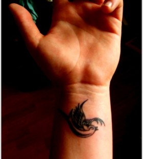 Small swallow wrist tattoo