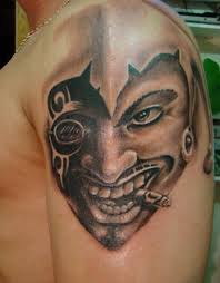 Smoking clown arm tattoo
