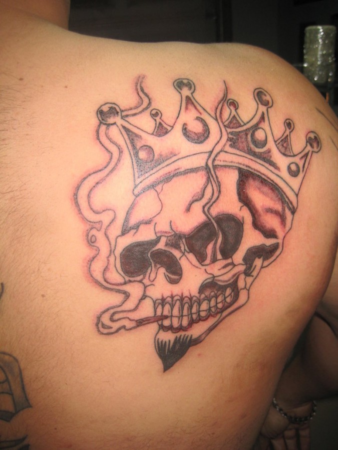Smoking skull with a crown tattoo