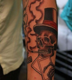 Smoking skull with cards tattoo