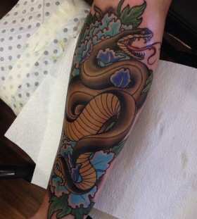 Snake tattoo on arm by Drew Shallis