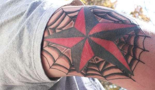 Spider web and star tattoo