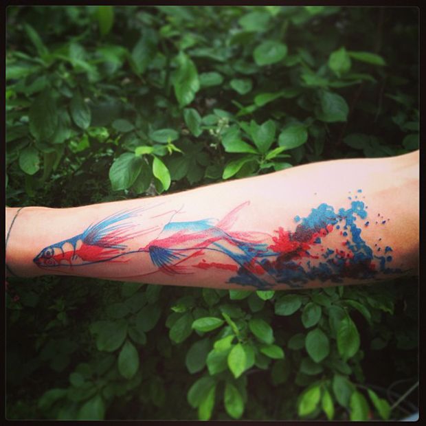 Stunning blue and red fish tattoo