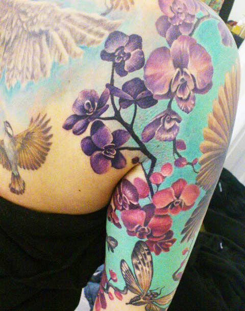 Stunning flowers arm tattoo by Ellen Westholm
