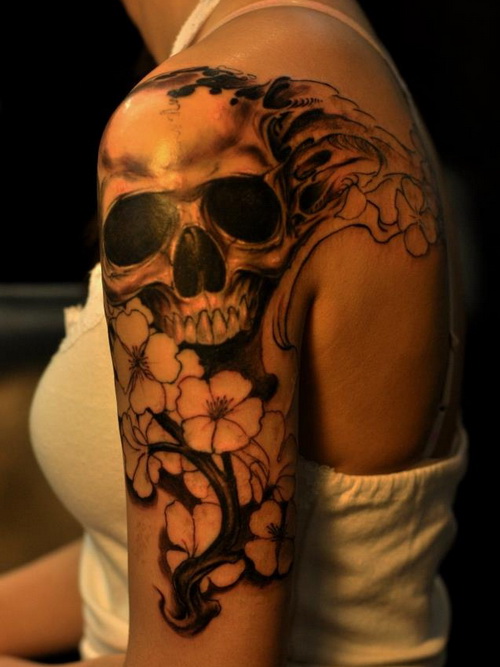 Stunning skull and flowers tattoo