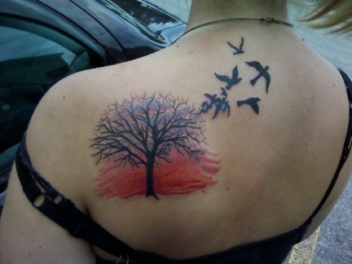Sunset and tree back tattoo