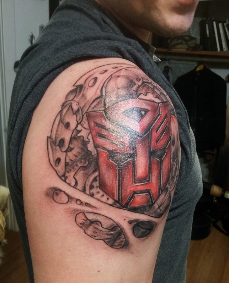 Transformers logo shoulder tattoo