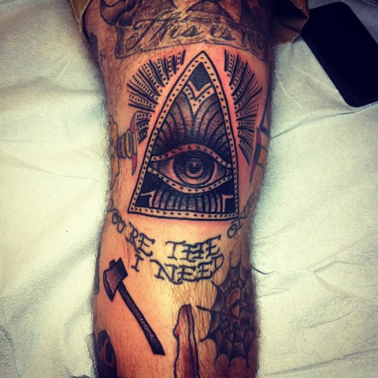 Triangle eye knee tattoo