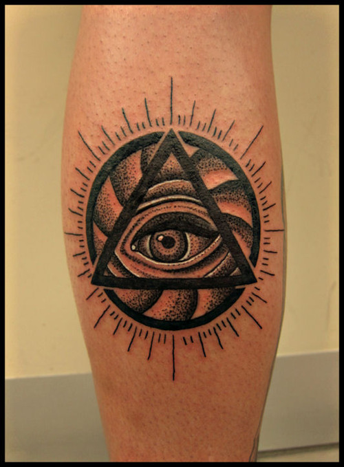 Triangle eye leg tattoo