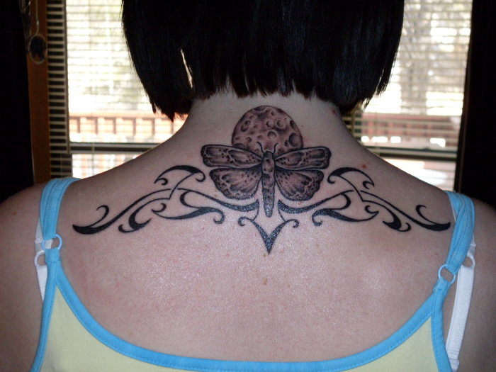 Tribal moth back tattoo