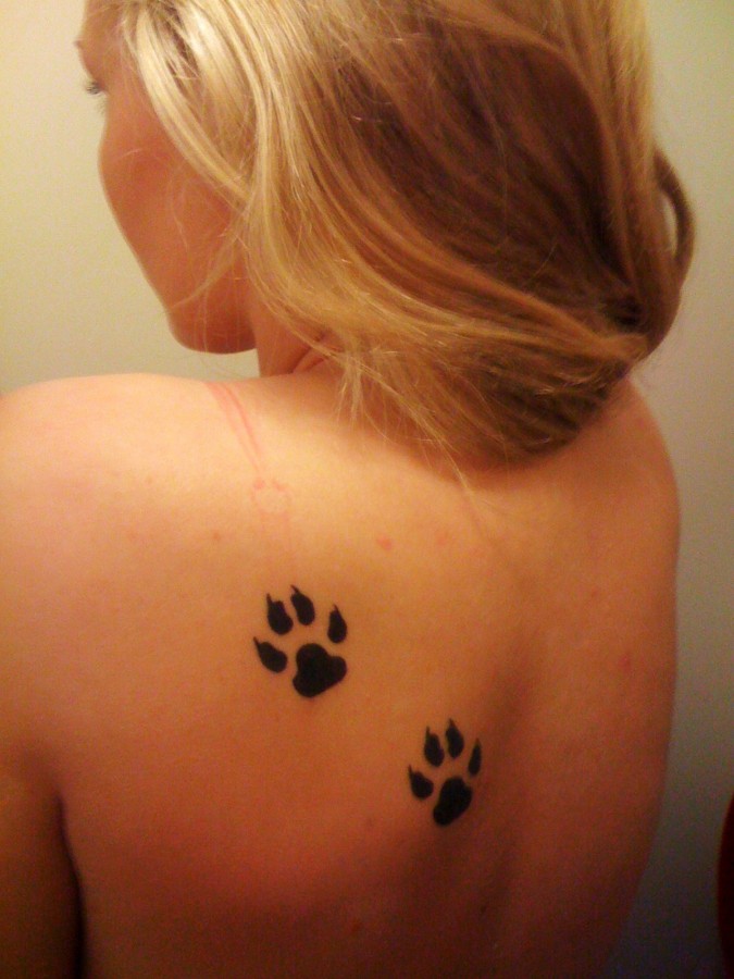 Two paws back tattoo