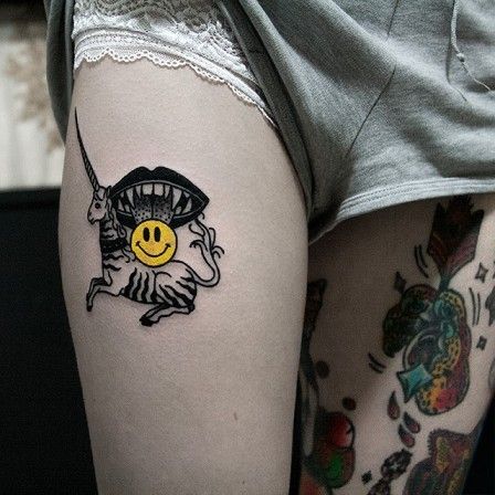 Unicorn and smiley face tattoo by Dase Roman Sherbakov
