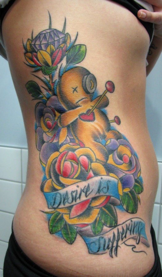 Voodoo doll and flowers tattoo