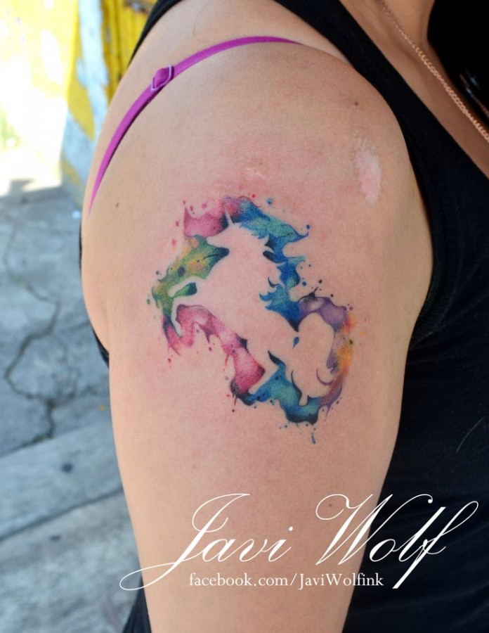 Watercolor style shoulder unicorn tattoo