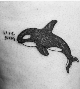 Whale and writing tattoo