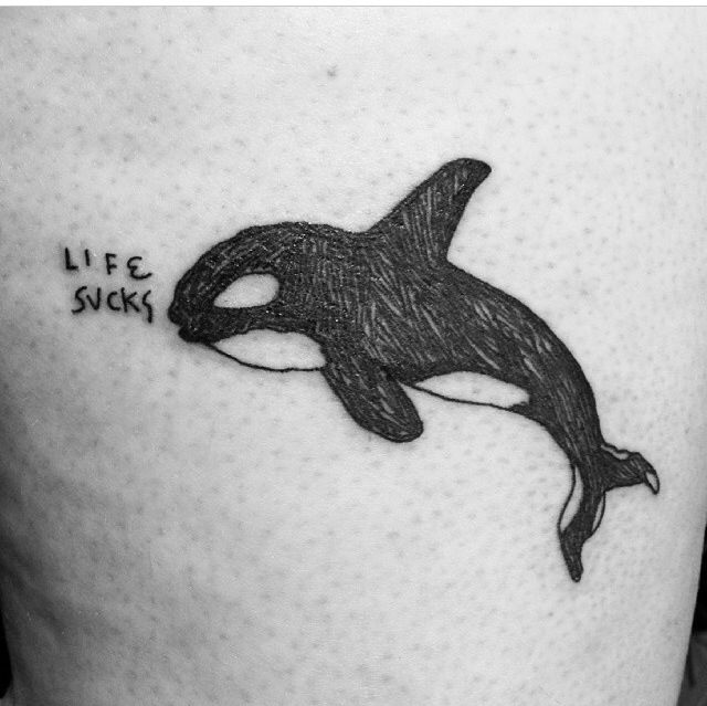 Whale and writing tattoo