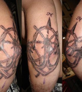 Wheel and anchor arm tattoo