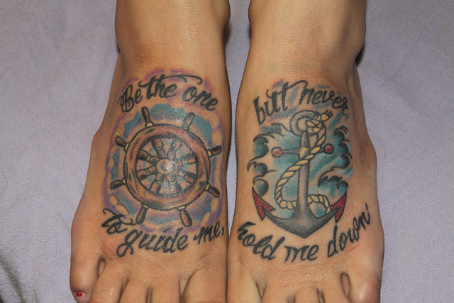 Wheel and quote foot tattoo