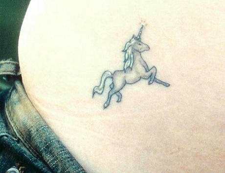 White and black unicorn tattoo