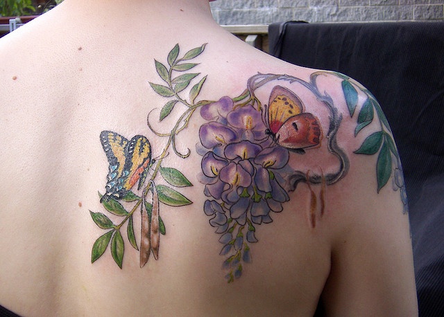 Wisteria and butterflies tattoo by Esther Garcia